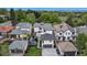 Aerial view showcasing a neighborhood's modern home with a backyard pergola, lush landscaping, and surrounding residences at 220 Glencoe St, Denver, CO 80220