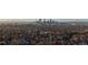 Sweeping aerial view showcasing Denver skyline, lush treeline, and surrounding city at 220 Glencoe St, Denver, CO 80220