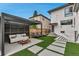 Landscaped backyard offers a modern outdoor living space with a pergola and patio at 220 Glencoe St, Denver, CO 80220