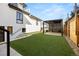 Landscaped backyard with artificial grass and a modern pergola at 220 Glencoe St, Denver, CO 80220