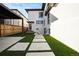 Backyard with artificial grass, a pergola, and walkway at 220 Glencoe St, Denver, CO 80220