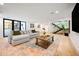 Spacious basement living room featuring modern finishes and staircase at 220 Glencoe St, Denver, CO 80220
