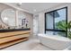 Bright bathroom featuring modern vanity with stone countertop and soaking tub at 220 Glencoe St, Denver, CO 80220