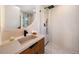Modern bathroom with neutral decor featuring a glass shower and unique vanity at 220 Glencoe St, Denver, CO 80220