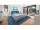 Sun-filled bedroom with balcony access, plush rug, and comfortable king bed at 220 Glencoe St, Denver, CO 80220