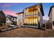 Modern two-story home featuring stone accents, wood siding, balcony, and a well-manicured front yard at 220 Glencoe St, Denver, CO 80220