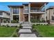 Stunning modern home featuring stone accents, expansive windows, and a beautifully landscaped front yard at 220 Glencoe St, Denver, CO 80220