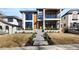 Modern home exterior with stone accents, wood trim, and concrete walkway at 220 Glencoe St, Denver, CO 80220