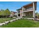 A modern home with a lush front yard and stepping stone path leading to the main entrance at 220 Glencoe St, Denver, CO 80220