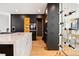 Modern kitchen with high-end appliances, marble island, and built-in wine storage is an entertainer's dream at 220 Glencoe St, Denver, CO 80220
