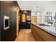 Modern kitchen featuring sleek cabinetry, stainless steel appliances, a wine rack, and hardwood floors at 220 Glencoe St, Denver, CO 80220