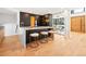 Sleek kitchen with marble island, breakfast bar seating, and modern black cabinetry at 220 Glencoe St, Denver, CO 80220