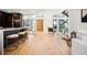 Open-concept area featuring modern decor, hardwood floors, a wine rack and comfortable seating at 220 Glencoe St, Denver, CO 80220