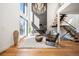 Bright living room with hardwood floors, fireplace, statement chandelier, and open staircase at 220 Glencoe St, Denver, CO 80220