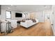 Bright living room with hardwood floors, white sofas, and large screen TV at 220 Glencoe St, Denver, CO 80220