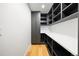 Well-organized pantry with built-in shelving and cabinets, offering ample storage space and hardwood flooring at 220 Glencoe St, Denver, CO 80220