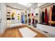 Spacious walk-in closet with custom shelving, ample storage, and a stylish bench for added convenience at 220 Glencoe St, Denver, CO 80220