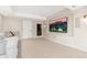 Cozy basement living area with a large TV, neutral carpet, and comfortable seating at 2832 Danbury Ave, Highlands Ranch, CO 80126