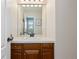 Powder room with a single sink vanity, framed mirror and warm neutral paint at 2832 Danbury Ave, Highlands Ranch, CO 80126