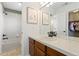 Bathroom featuring a shower-tub combination, vanity, framed art, and closet access at 2832 Danbury Ave, Highlands Ranch, CO 80126