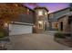 Stunning exterior featuring a stone turret, attached garage, and a paved driveway at 2832 Danbury Ave, Highlands Ranch, CO 80126