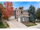 Charming home showcasing a stone turret, mature trees, and a well-maintained lawn at 2832 Danbury Ave, Highlands Ranch, CO 80126