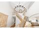 Grand foyer boasting a high ceiling, large chandelier, and a staircase with wooden railing at 2832 Danbury Ave, Highlands Ranch, CO 80126