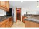 Kitchen with wood cabinets, stainless appliances and opening to wine cellar at 2832 Danbury Ave, Highlands Ranch, CO 80126