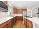 Well-equipped kitchen with stainless appliances, white countertops and wooden cabinetry at 2832 Danbury Ave, Highlands Ranch, CO 80126