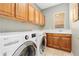 Functional laundry room with modern appliances, ample storage cabinets, and a utility sink at 2832 Danbury Ave, Highlands Ranch, CO 80126