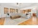 Spacious living room featuring hardwood floors, an oversized couch, and lots of natural light at 2832 Danbury Ave, Highlands Ranch, CO 80126