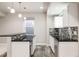 Basement wet bar with granite countertop and modern cabinetry at 4942 Wabash St, Denver, CO 80238