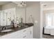 Double vanity bathroom with granite countertop and view to bedroom at 4942 Wabash St, Denver, CO 80238