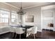 Elegant dining room with a large table, chandelier, and hardwood floors at 4942 Wabash St, Denver, CO 80238