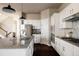 Modern kitchen with white cabinets, granite countertops, and stainless steel appliances at 4942 Wabash St, Denver, CO 80238