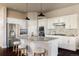 Modern kitchen with white cabinets, granite countertops, and stainless steel appliances at 4942 Wabash St, Denver, CO 80238