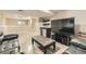 Finished basement features a seating area, entertainment center, and convenient kitchenette at 6225 E Mississippi Ave, Denver, CO 80224