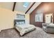 Cozy bedroom with vaulted ceiling, wooden beams, and soft carpet, offering a comfortable relaxing space at 6225 E Mississippi Ave, Denver, CO 80224