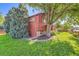 The house with mature trees and lush green lawn, nestled in a charming landscape at 6225 E Mississippi Ave, Denver, CO 80224