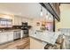 Updated kitchen with granite countertops, stainless steel appliances, and a breakfast bar overlooking the dining area at 6225 E Mississippi Ave, Denver, CO 80224