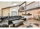 Open-concept living space with vaulted ceiling, wooden beams, and seamless access to the kitchen and dining areas at 6225 E Mississippi Ave, Denver, CO 80224