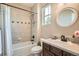 Cozy bathroom featuring shower over tub, and stylish fixtures and decor at 15496 W 66Th Dr # G, Arvada, CO 80007