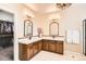 Elegant bathroom with dual vanities, decorative mirrors, and classic lighting fixtures at 15496 W 66Th Dr # G, Arvada, CO 80007