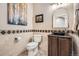 Charming powder room with decorative tile and elegant fixtures at 15496 W 66Th Dr # G, Arvada, CO 80007