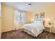 Bright bedroom features neutral tones, natural light and a comfortable queen-sized bed at 15496 W 66Th Dr # G, Arvada, CO 80007