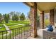 Charming covered porch features stone pillars and comfortable seating area, offering a relaxing outdoor space at 15496 W 66Th Dr # G, Arvada, CO 80007