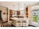 Kitchen with a marble countertop island, pendant lighting, and wooden cabinets at 15496 W 66Th Dr # G, Arvada, CO 80007