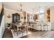 Open-concept kitchen and dining area with modern appliances, wooden cabinetry, and hardwood floors at 15496 W 66Th Dr # G, Arvada, CO 80007