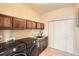 Well-equipped laundry room features modern appliances, counter space, and ample storage at 15496 W 66Th Dr # G, Arvada, CO 80007