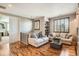 Second-floor living area with hardwood floors, built-in shelving, and neutral decor at 15496 W 66Th Dr # G, Arvada, CO 80007